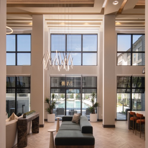 large two story room with ample seating a fireplace and a tv