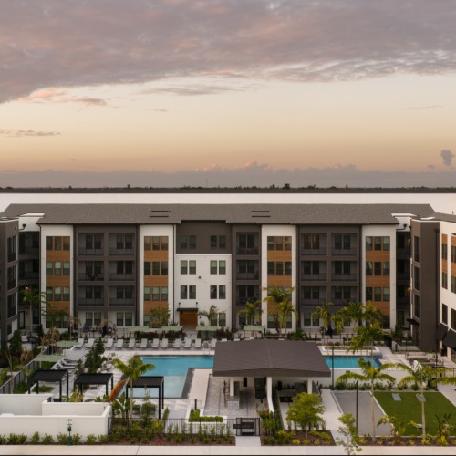 outdoor area with resort style pool and outdoor gaming and kitchen 