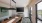 room with long table and ample seating with a tv on the wall