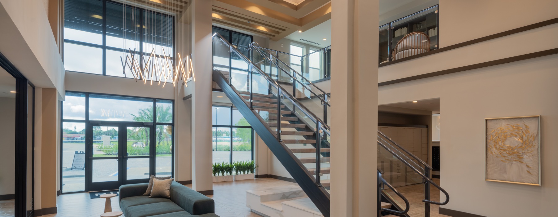 two story room with a staircase and ample windows 