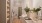 bathroom with two sinks and backlit mirrors with a bathtub in the back 