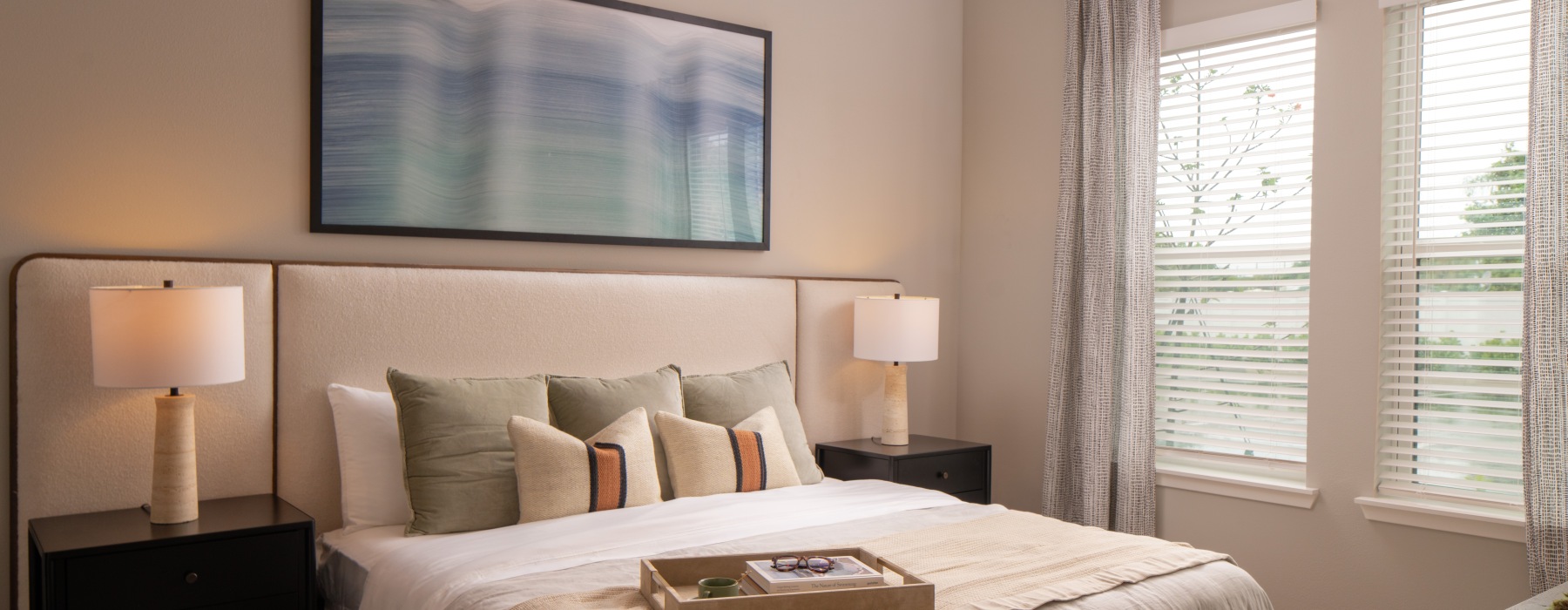 Bedroom with bed and side tables with a large window
