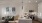 kitchen with counter seating open to living area with green couch and coffee table