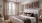 well lit bedroom with bed and a large window