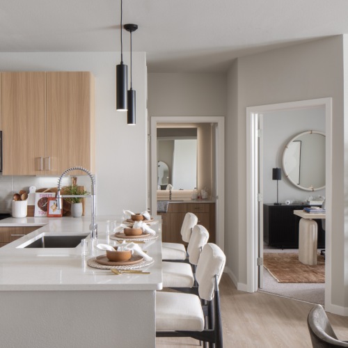 kitchen with bar stools and a plant